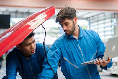 auto mechanics working together on car repair services